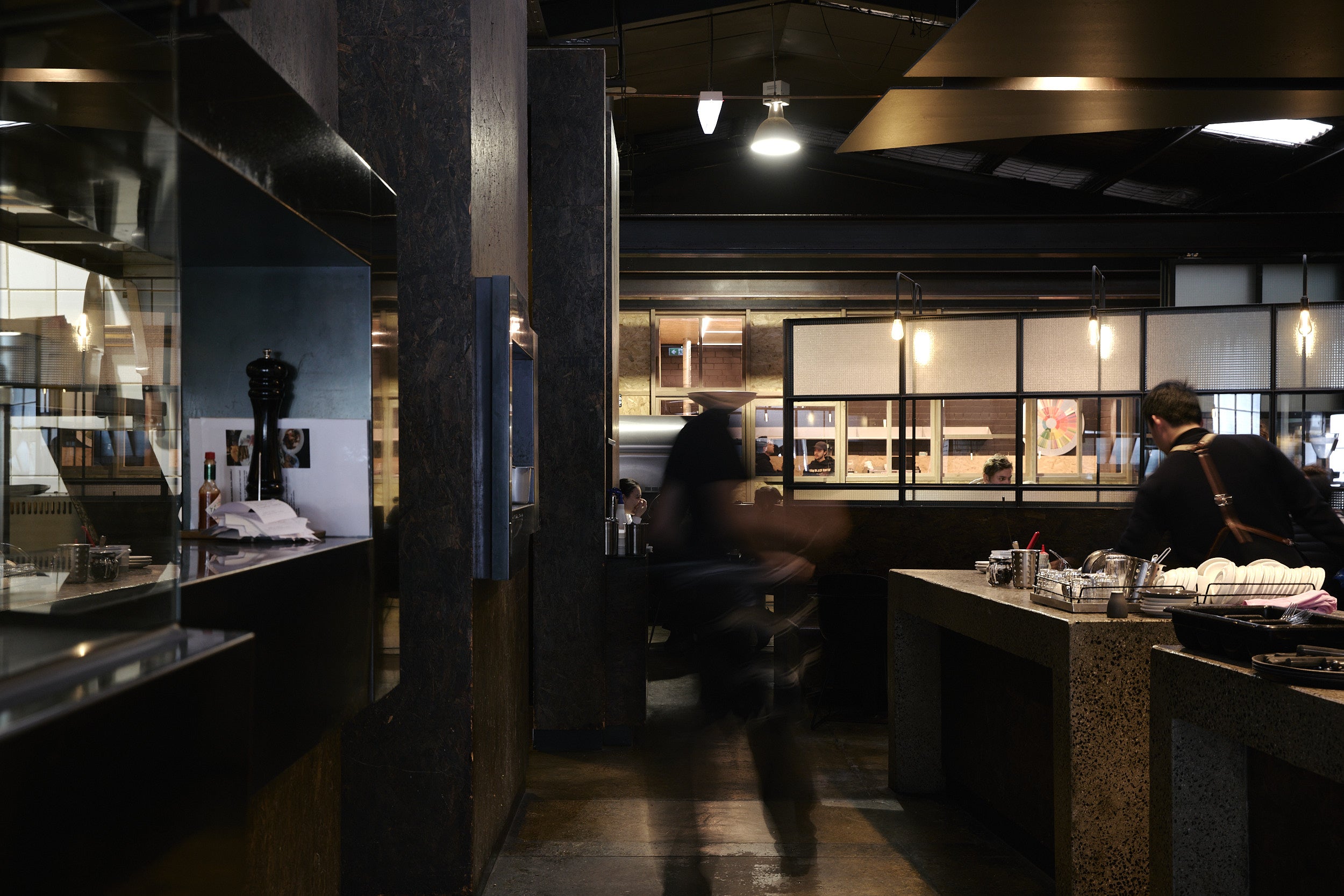 Dark interior of a restaurant with patrons and decor