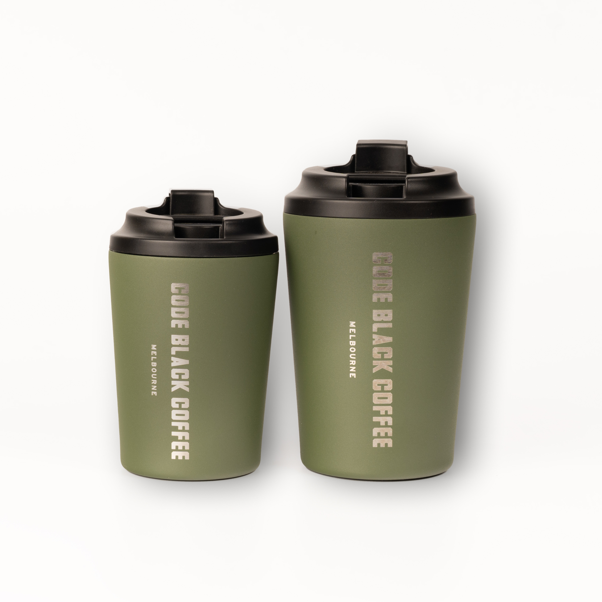 Two green Fressko coffee cups with black lids on a white background