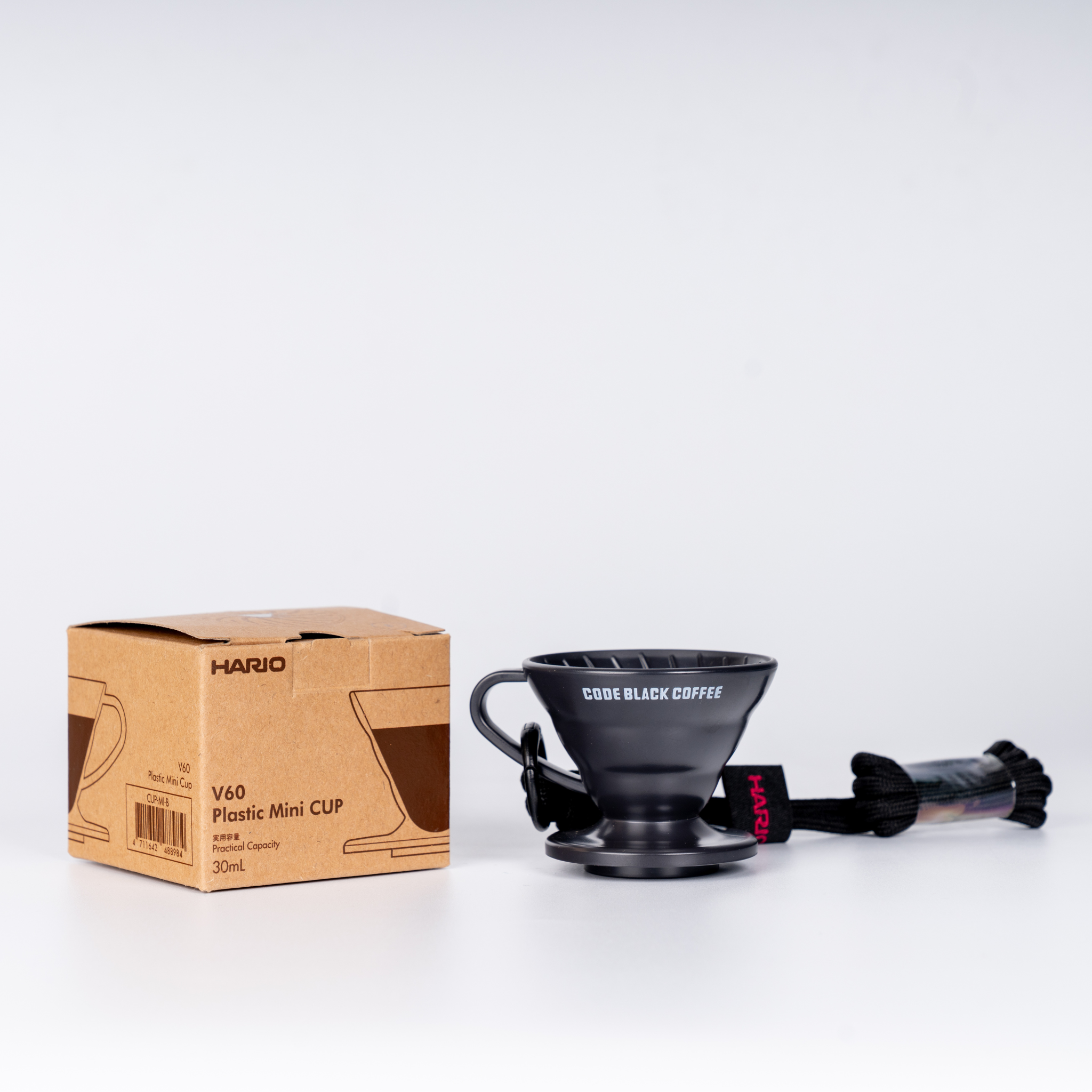 Black coffee tasting cup with Hario box on a white background